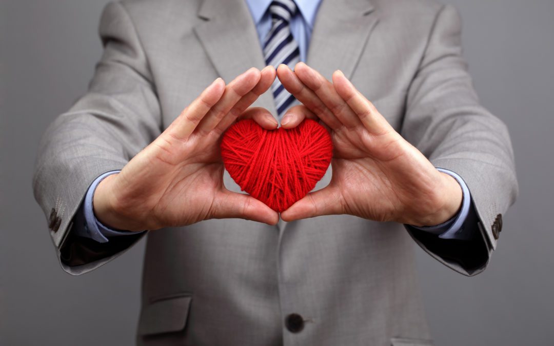 Man holding a red woolen heart concept for valentine's day