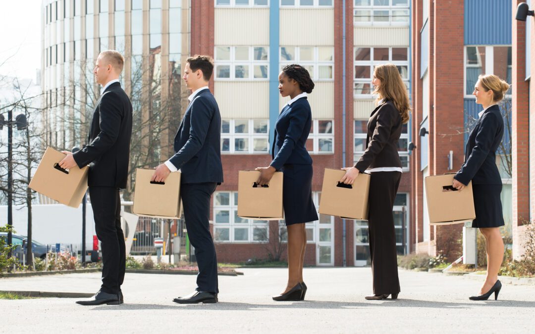 Businesspeople With Boxes Standing In A Line